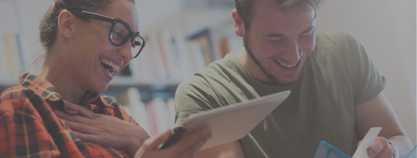 A male and female laughing in the library at BVC