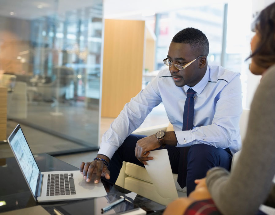 Man in business clothing using laptop