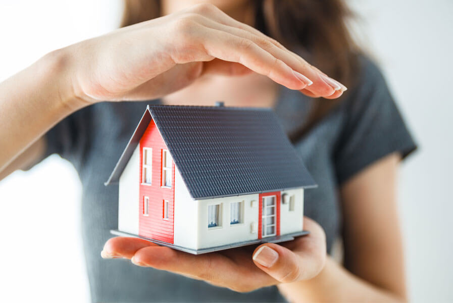 Woman holding model house