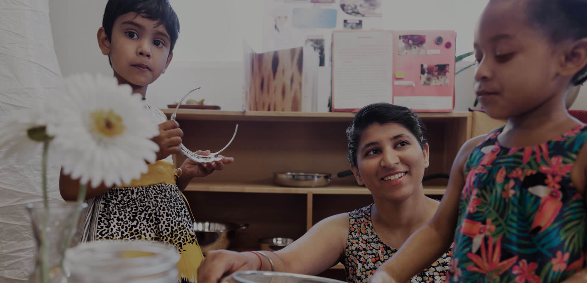 Child care worker playing with two children