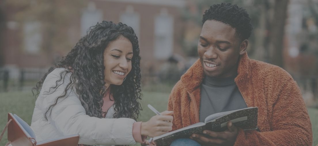 Two Bow Valley College students sitting outside, studying together, campus life