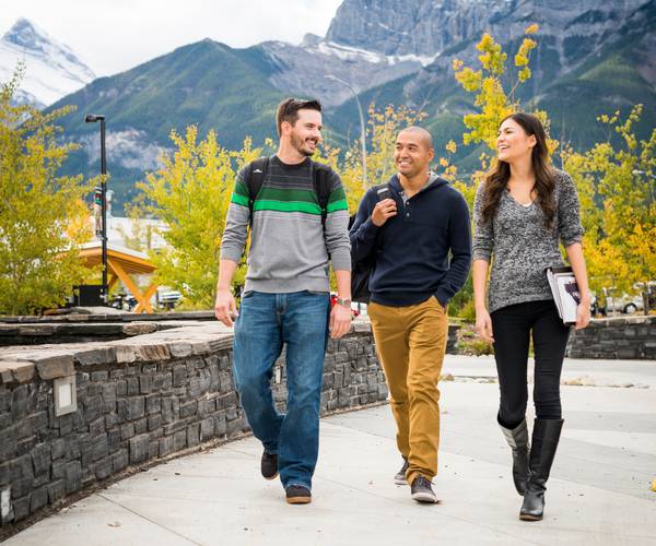 Three students walking down the street