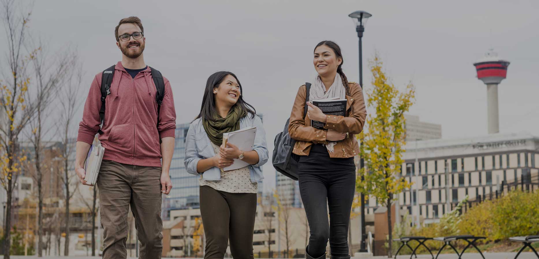 Three students walking through East Village